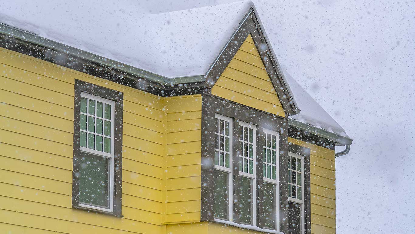 Yellow house and snow